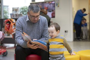 Granddad reading with his grandson